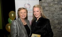 Minister Fitzgerald presents Ashley Power with a raffle prize of a digital camera